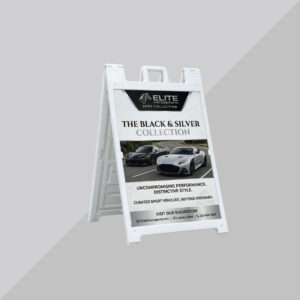 White A-frame sign advertising luxury vehicles and premium dealership offers
