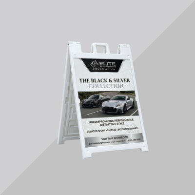 White A-frame sign advertising luxury vehicles and premium dealership offers